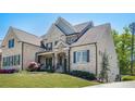 Beautiful brick house with well-maintained lawn, mature trees, and architectural details at 5335 Briarstone Ridge Way, Alpharetta, GA 30022