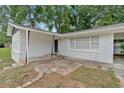 Inviting front porch and entrance with whitewashed brick and covered carport at 1520 Oxford St, Douglasville, GA 30134