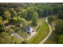 Expansive aerial view of a quaint home surrounded by mature trees and large verdant lawn at 780 Old Magnolia Trl, Canton, GA 30115