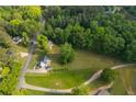 Scenic aerial perspective reveals a beautiful home surrounded by lush greenery and tree coverage at 780 Old Magnolia Trl, Canton, GA 30115