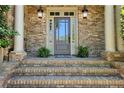 Charming brick home featuring a glass front door with sidelights and brick steps at 1632 Brookhaven Close Ne, Atlanta, GA 30319