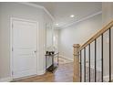 Home entryway featuring hardwood floors, staircase with railing, and decoratively appointed with a mirror and table at 354 Hayden Cir, Woodstock, GA 30189