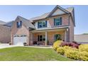 Inviting brick home with a lush front yard and colorful landscaping at 55 Sudderth St, Buford, GA 30518