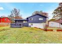 Backyard view showcasing a lush lawn and charming deck, perfect for outdoor entertaining at 8451 Magnolia Dr, Jonesboro, GA 30238