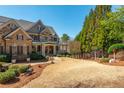 Picturesque home with a combination of brick and stone, and a beautifully landscaped front yard at 930 Shepards Ct, Roswell, GA 30075