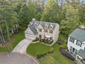 Aerial view of a lovely two-story home on a well-manicured lawn in a quiet neighborhood at 10090 Feather Sound Ct, Alpharetta, GA 30022