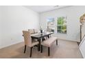 Bright dining room with large windows, a modern table with seating for six, and neutral carpeting at 1560 Avalon Creek Rd, Sugar Hill, GA 30518