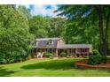 Traditional brick home with a manicured front lawn and colorful shrubbery at 110 Sandy Ridge Trl, Fayetteville, GA 30214