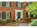 Inviting brick home featuring a classic front door with decorative accents and lush landscaping at 2144 Lamplight Dr, Marietta, GA 30062
