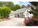 Attractive single-story home with stone accents, attached garage, and mature landscaping at 5042 Southland Dr, Woodstock, GA 30188