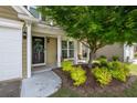 Welcoming front porch with a decorative wreath, chairs, and lush landscaping at 6030 Pattingham Dr, Roswell, GA 30075