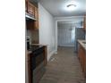 Galley-style kitchen featuring stainless steel appliances and wood finish cabinets at 1131 Indale Sw Pl, Atlanta, GA 30310