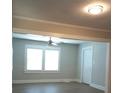 Open living area with modern flooring, ceiling fan, and large windows for natural light at 1131 Indale Sw Pl, Atlanta, GA 30310
