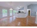 Open-concept living room with hardwood floors, neutral paint, and great natural light at 3342 Windpointe Ct, Buford, GA 30519