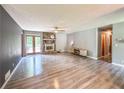 Open concept living room features a ceiling fan, wood floors, stone fireplace, and a sliding glass door at 3814 Lamar Way, Snellville, GA 30039