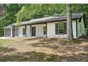 Lovely home featuring stone accents, dark shutters, and a well-manicured lawn at 250 Huntcliff Ct, Fayetteville, GA 30214