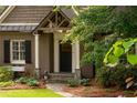 Inviting front porch with stone accents and lush landscaping create a welcoming entrance at 3115 Peachtree Ne Dr, Atlanta, GA 30305