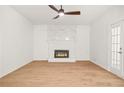 Unfurnished living room boasts wood floors, a fireplace, and ample natural light at 230 Deer Forest Rd, Fayetteville, GA 30214