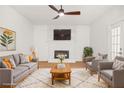 Bright living room features a decorative fireplace, wood floors, and modern furniture at 230 Deer Forest Rd, Fayetteville, GA 30214