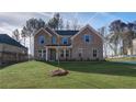 Charming brick home featuring a well-maintained lawn and a covered entryway, perfect for a welcoming feel at 322 Delta Dr, Mcdonough, GA 30253
