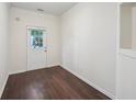 Bright flex space featuring hardwood floors, neutral paint, and a door to the outdoor space at 6071 Apple Grove Rd, Buford, GA 30519