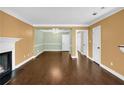Spacious living and dining area with hardwood floors, fireplace, elegant chandelier, and neutral paint at 84 Mount Vernon Cir, Atlanta, GA 30338