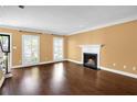 Bright living room boasts hardwood floors, a fireplace, and abundant natural light from large windows at 84 Mount Vernon Cir, Atlanta, GA 30338
