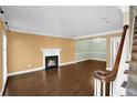 Inviting living room featuring hardwood floors, fireplace, staircase, and neutral paint colors at 84 Mount Vernon Cir, Atlanta, GA 30338