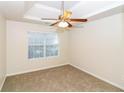 Neutral bedroom featuring a ceiling fan and a window allowing ample natural light to enter the room at 137 Legend Creek Dr, Canton, GA 30114