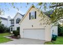 Spacious two car garage with driveway and partial view of the home's exterior at 137 Legend Creek Dr, Canton, GA 30114