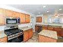 Modern kitchen featuring stainless steel appliances, granite countertops, and wood cabinets at 137 Legend Creek Dr, Canton, GA 30114