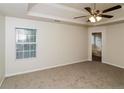 Large primary bedroom featuring a ceiling fan, a window, and an en-suite bath at 137 Legend Creek Dr, Canton, GA 30114