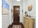 Stylish entryway showcasing hardwood floors, decorative art, and a solid wood door with modern hardware at 214 Vickery Falls Dr, Roswell, GA 30075
