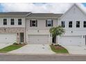 Townhome exteriors featuring painted brick, siding, manicured lawns, and two car garages at 4655 Larkfield Way, Powder Springs, GA 30127
