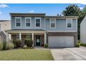 Two-story home with blue siding, brick accents, a two-car garage, and a well-manicured lawn at 5437 Blossom Brook Dr, Sugar Hill, GA 30518