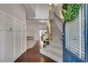Inviting foyer with hardwood floors, board and batten trim, and stairway leading to the upper level at 5437 Blossom Brook Dr, Sugar Hill, GA 30518