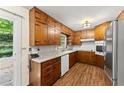 Classic kitchen with wood cabinets, granite countertops, stainless steel appliances, and a view of the backyard at 1190 Hess Dr, Avondale Estates, GA 30002