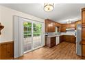 Warm kitchen featuring wooden cabinets, stainless steel appliances, granite countertops, and a sliding glass door at 1190 Hess Dr, Avondale Estates, GA 30002