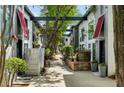 Charming courtyard with walkways, lush greenery, and potted plants between modern townhomes at 195 Arizona Ne Ave # 104, Atlanta, GA 30307