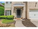 Charming home with a brick facade, neat landscaping, and a welcoming front door at 525 Roland Manor Dr, Dacula, GA 30019