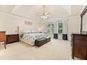 Spacious main bedroom featuring a tray ceiling, neutral decor, and a large window for natural light at 525 Roland Manor Dr, Dacula, GA 30019
