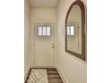 Welcoming entryway with stylish mirror and a view of a wooden front door at 1569 Aiden Way # 35, Conyers, GA 30013