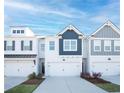 Charming townhome exterior featuring individual garage spaces and contemporary design at 1569 Aiden Way # 35, Conyers, GA 30013