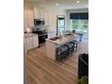 Bright, well-equipped kitchen featuring granite countertops, stainless steel appliances, and an island with bar stool seating at 1569 Aiden Way # 35, Conyers, GA 30013