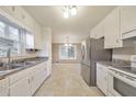 Functional kitchen featuring white cabinets, stainless steel appliances, and plenty of counter space at 1584 Allgood Ne Rd, Marietta, GA 30062