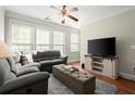 Cozy living room featuring hardwood floors, ceiling fan and large windows at 3708 Ashford Creek Ne Hl # 3708, Atlanta, GA 30319