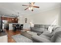 Open-concept living room with hardwood floors, ceiling fan and comfortable furniture at 3708 Ashford Creek Ne Hl # 3708, Atlanta, GA 30319