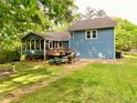 Back exterior with a screened porch and wooden deck perfect for outdoor relaxation at 5364 Muirwood Pl, Powder Springs, GA 30127