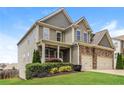 Beautiful two-story home with green lawn and mature landscaping on a sunny day at 626 Discovery Ct, Acworth, GA 30102