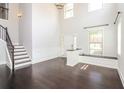 Bright, two-story foyer with hardwood floors, staircase, and large window at 626 Discovery Ct, Acworth, GA 30102